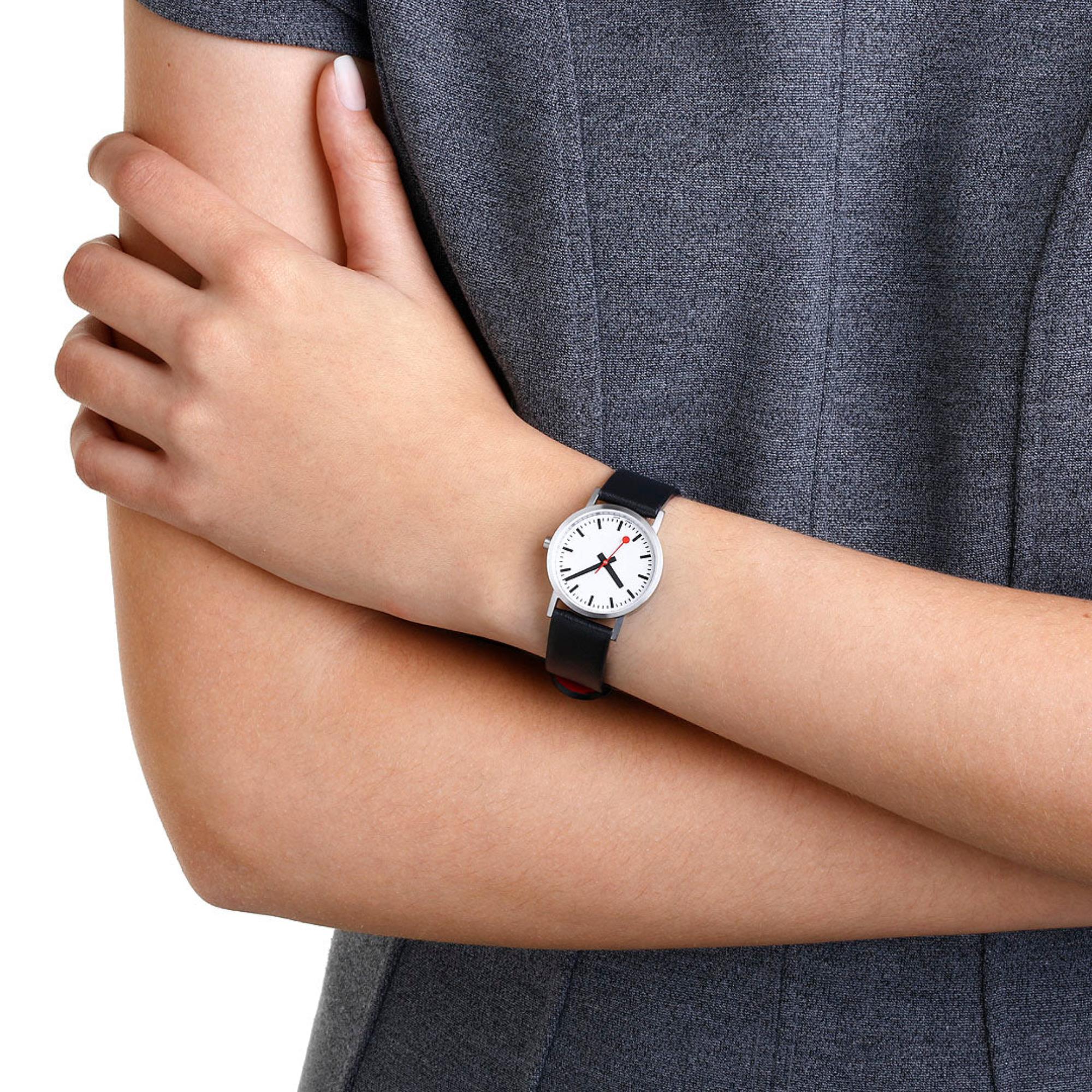 Mondaine Classic A658.30323.16OMV white dial with black markers and red second hand on a model's wrist