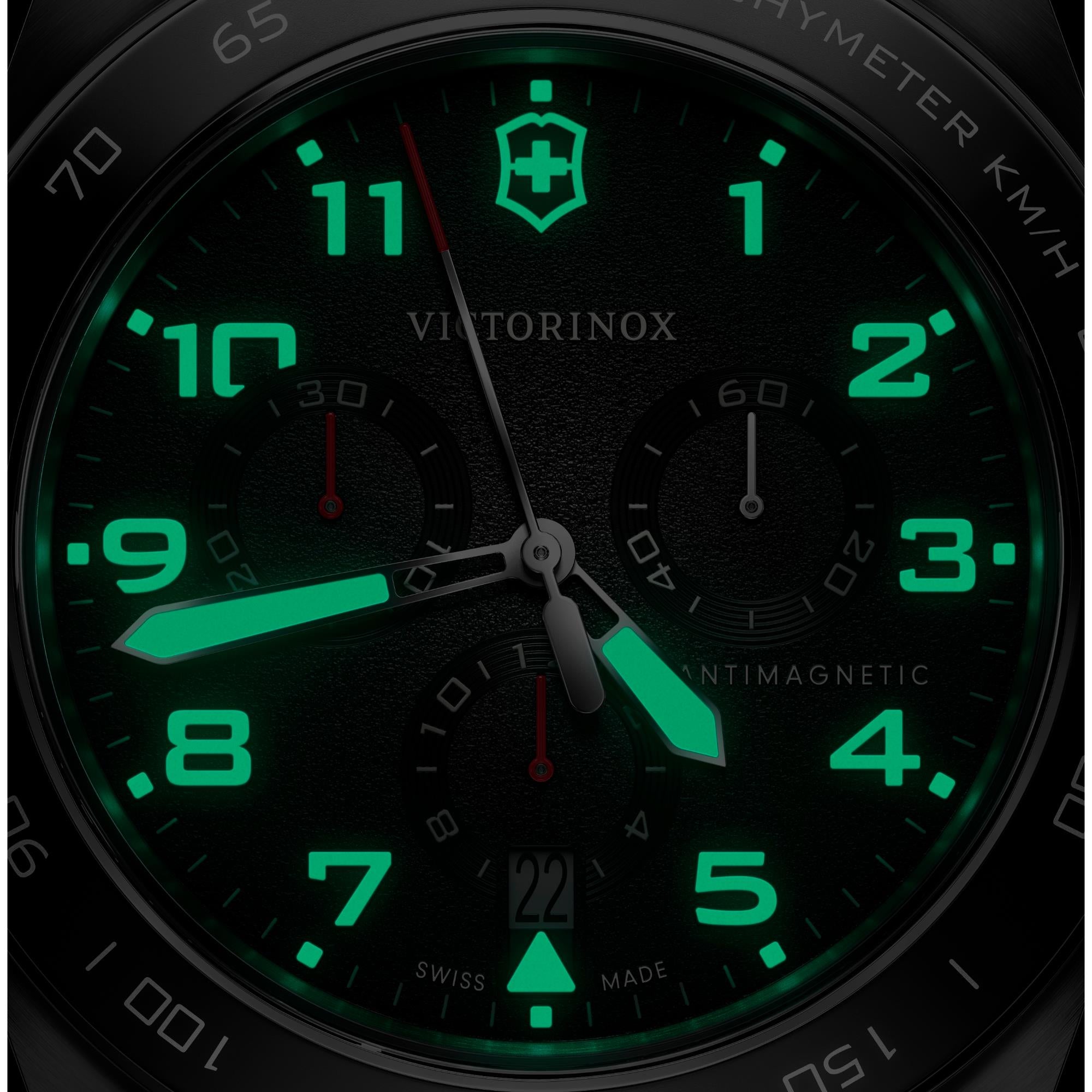 Victorinox Swiss Army 242046 chronograph watch with glowing markers on black dial in dark setting close-up