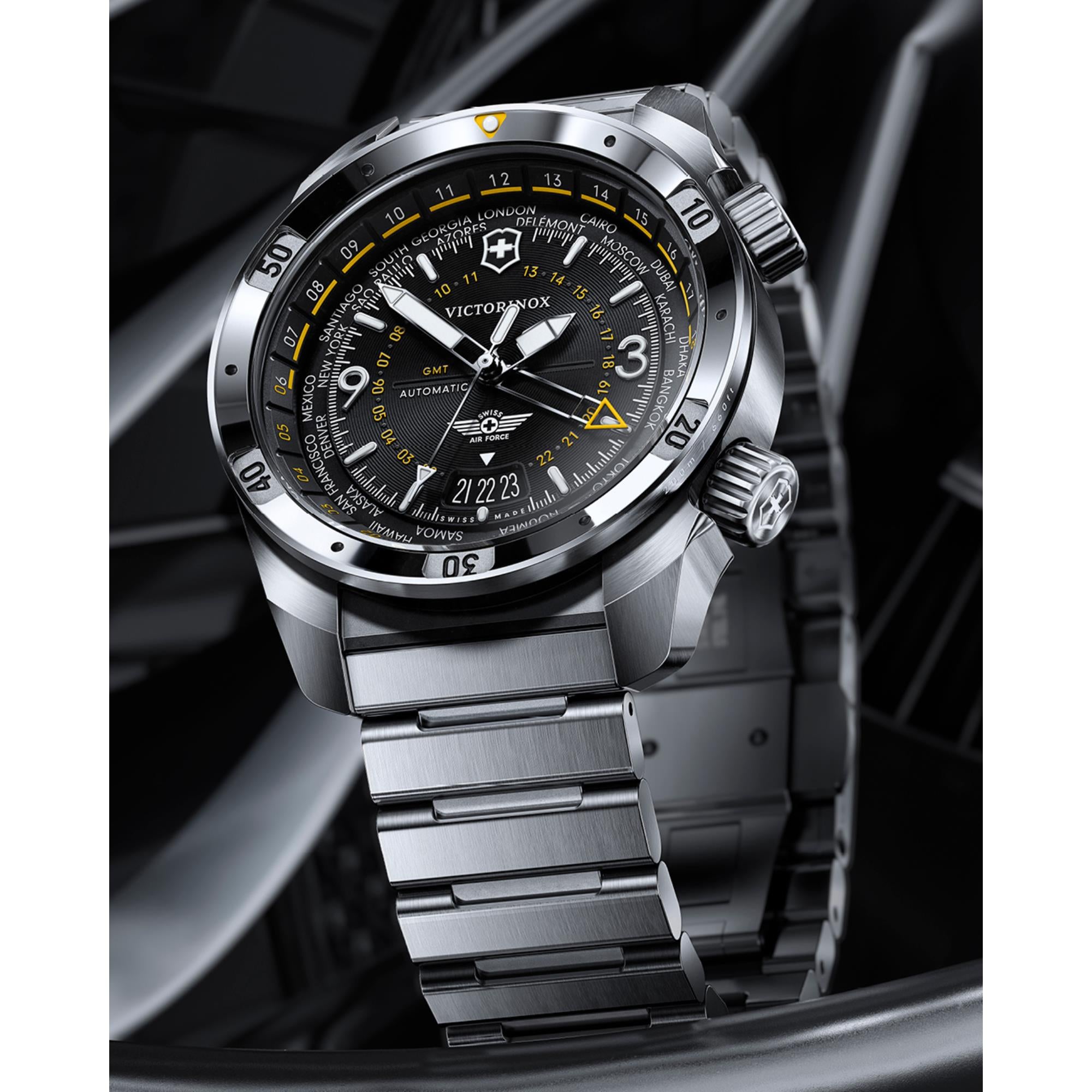 Dramatic angled lifestyle shot of Victorinox Air Pro 242004 GMT automatic watch with stainless steel bracelet