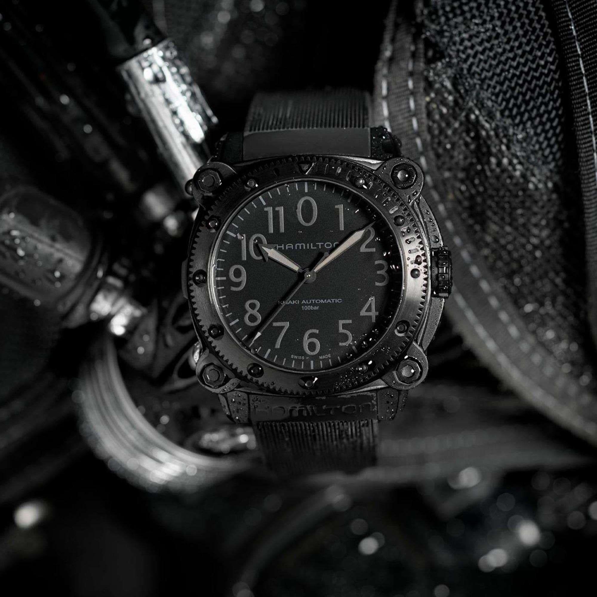 Hamilton Khaki Automatic black dive watch covered in water droplets, showcasing its rugged design and dive capabilities
