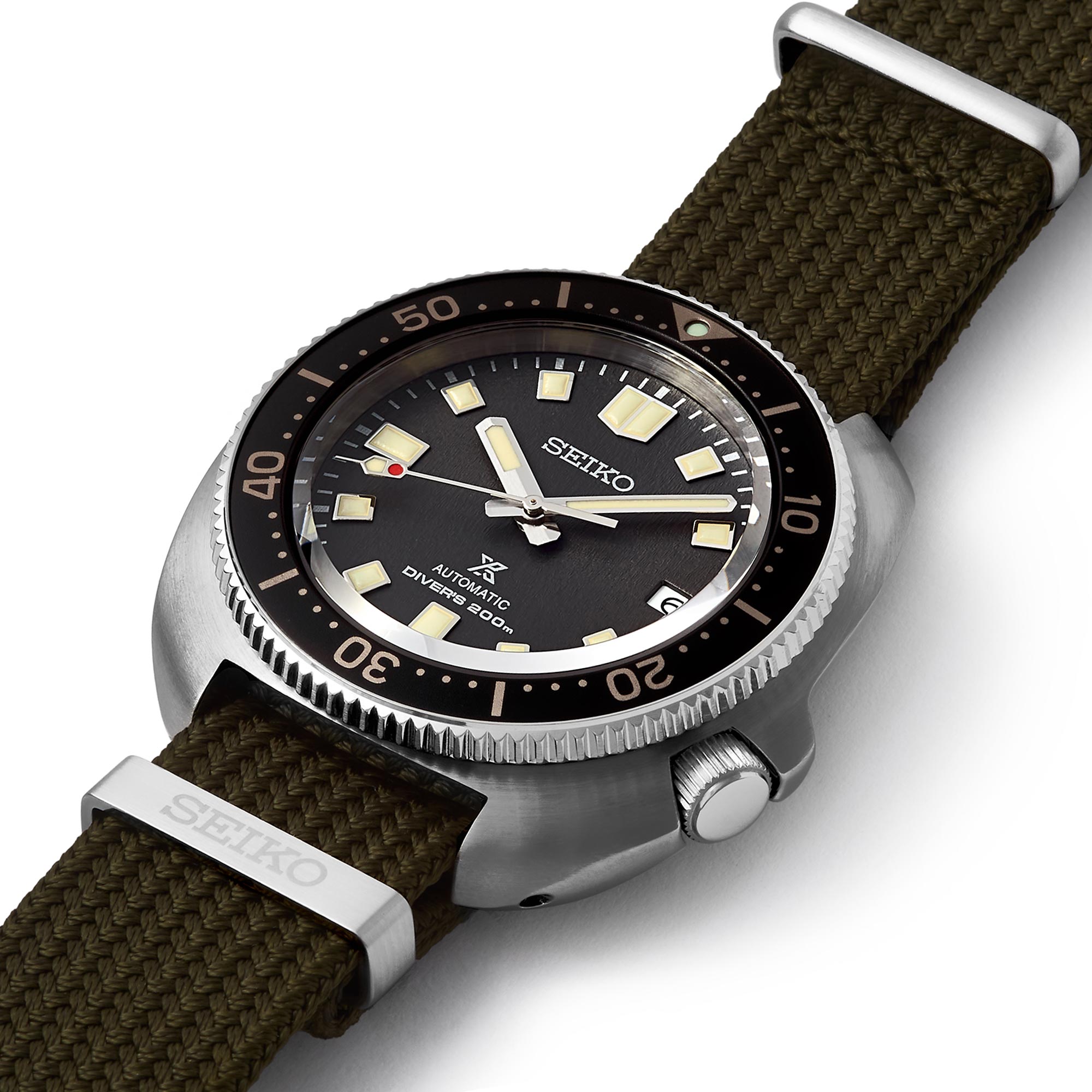 Seiko watch with brown strap and black dial on a white background