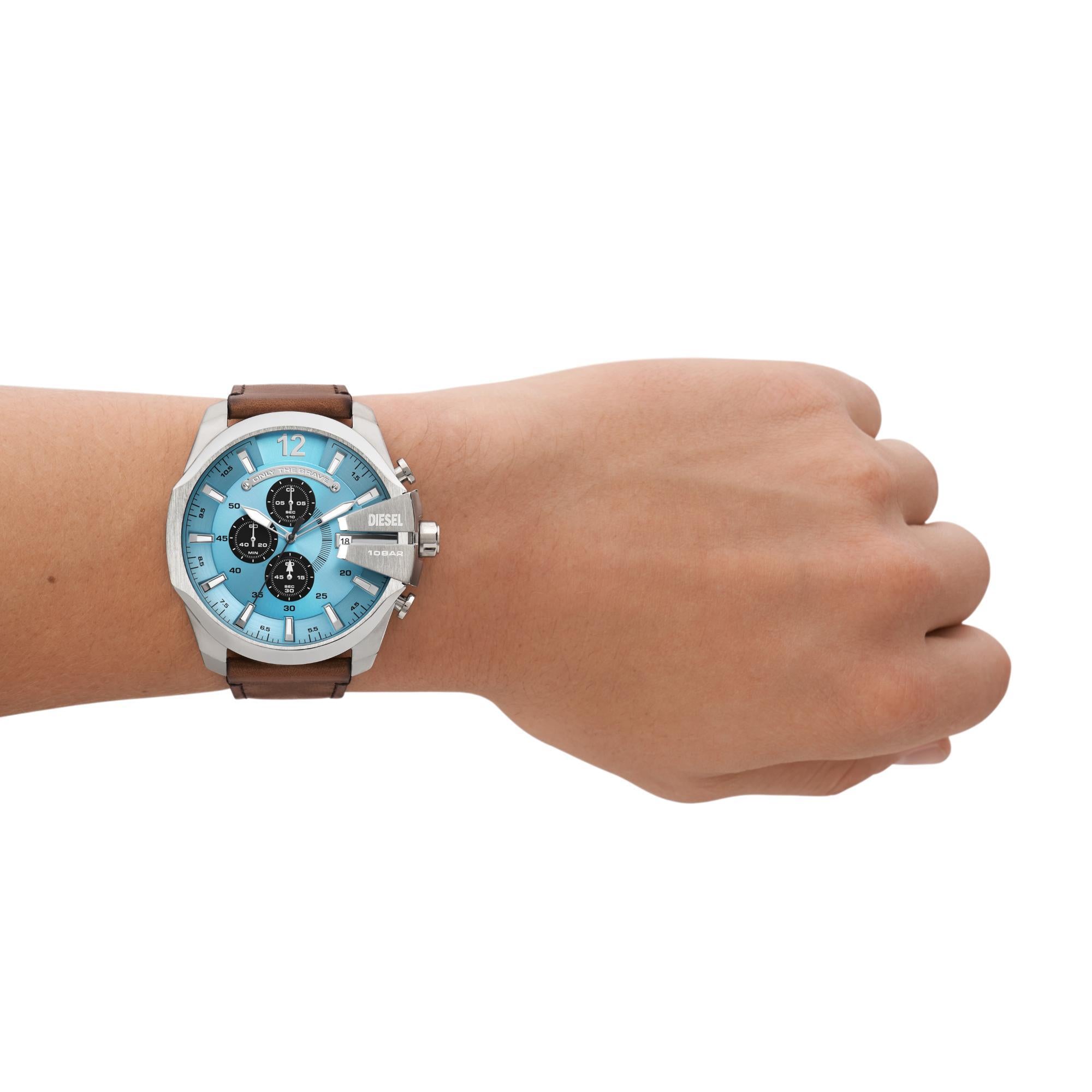 Wrist wearing a watch with a blue face and brown strap on a white background