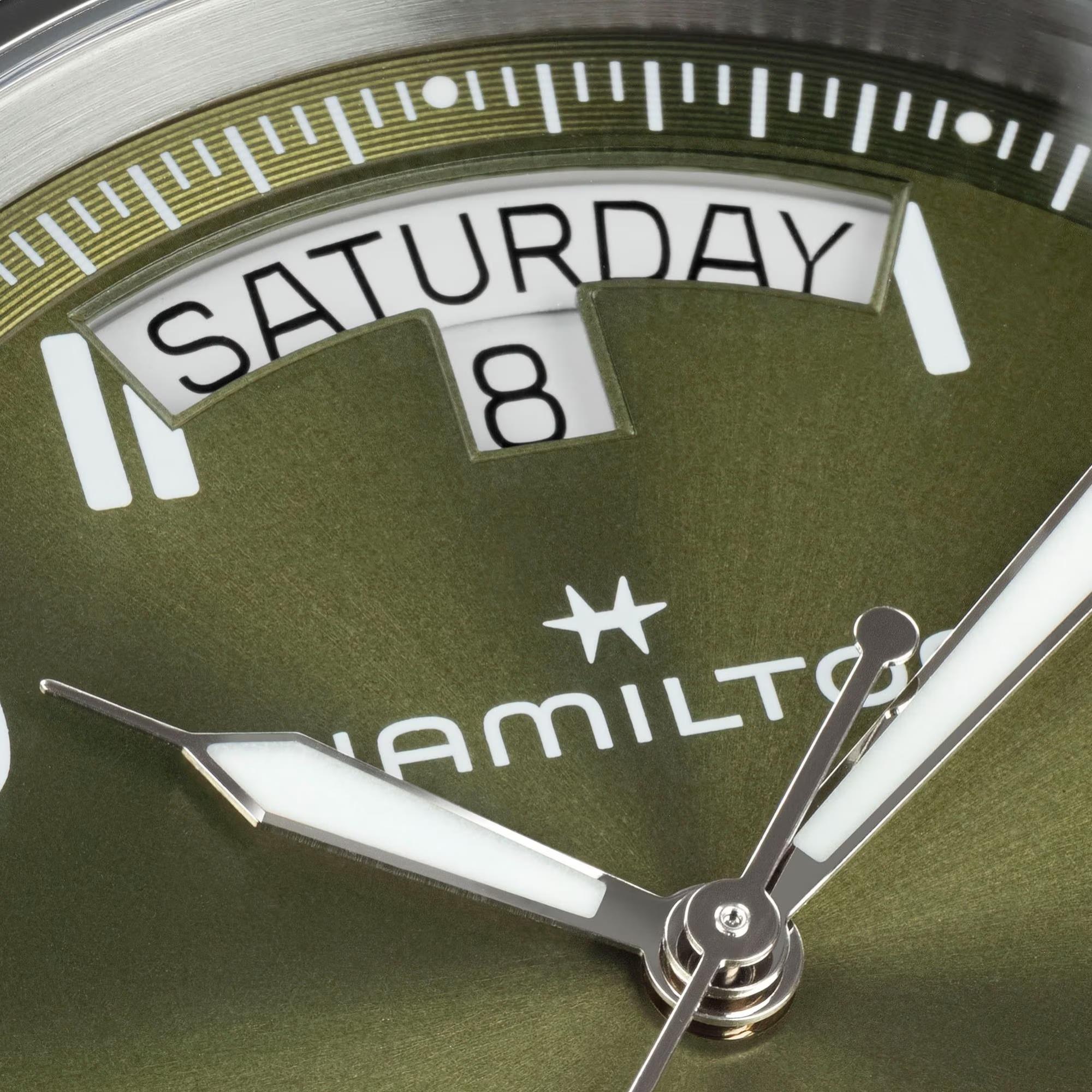 Hamilton H64475560 green sunray dial with day-date display at 12 o'clock and crown guards close-up