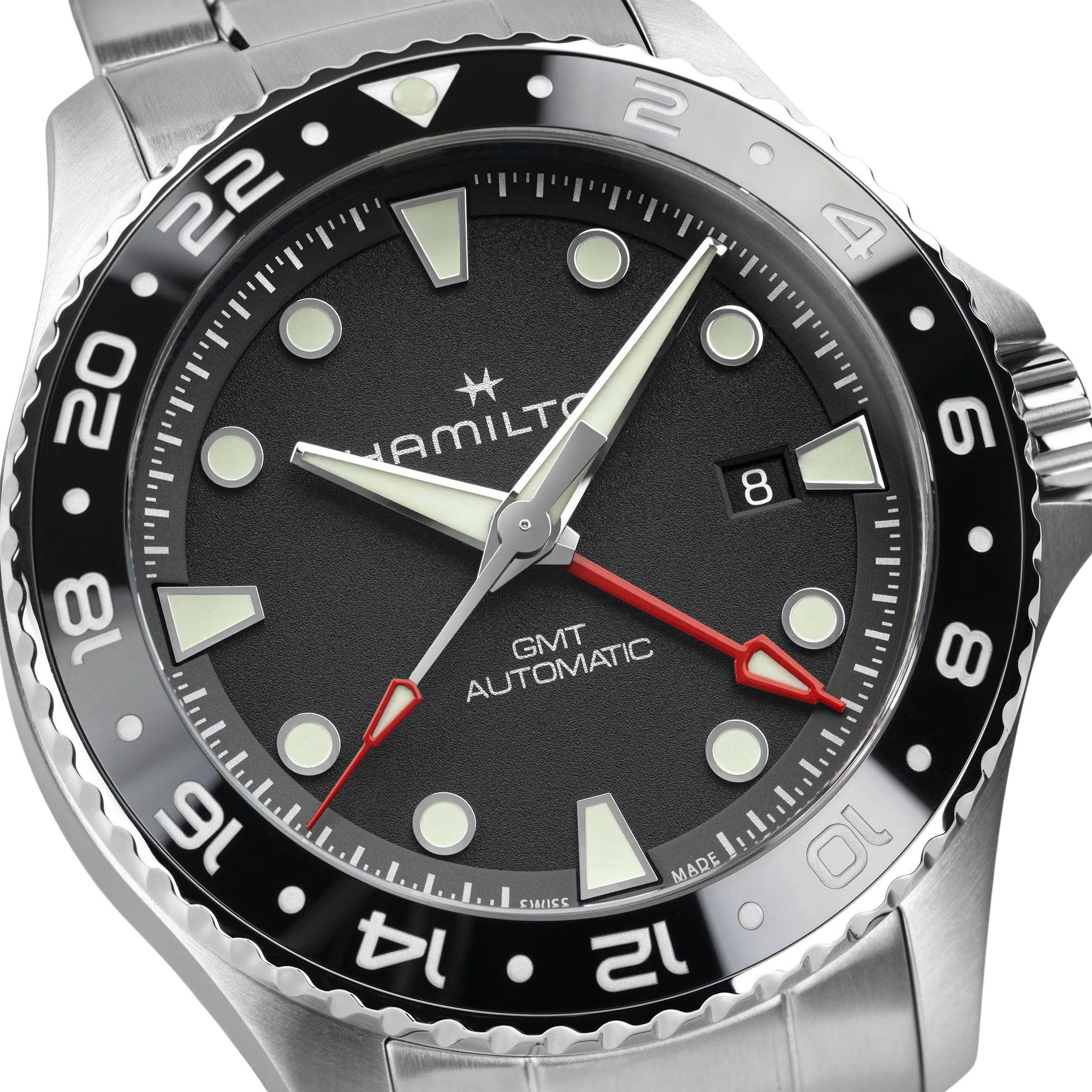 Hamilton Khaki Navy H82555130 black dial with red GMT hand and date display close-up