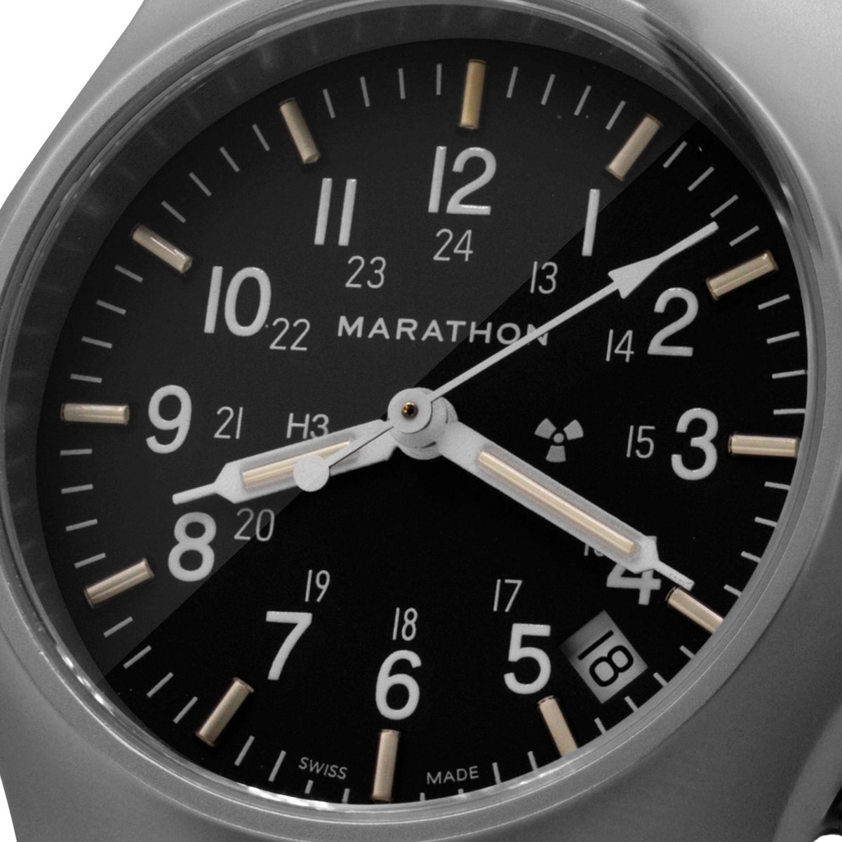 Marathon General Purpose Field WW194015SS-0101 quartz watch macro shot showing black dial with 24-hour scale and date window