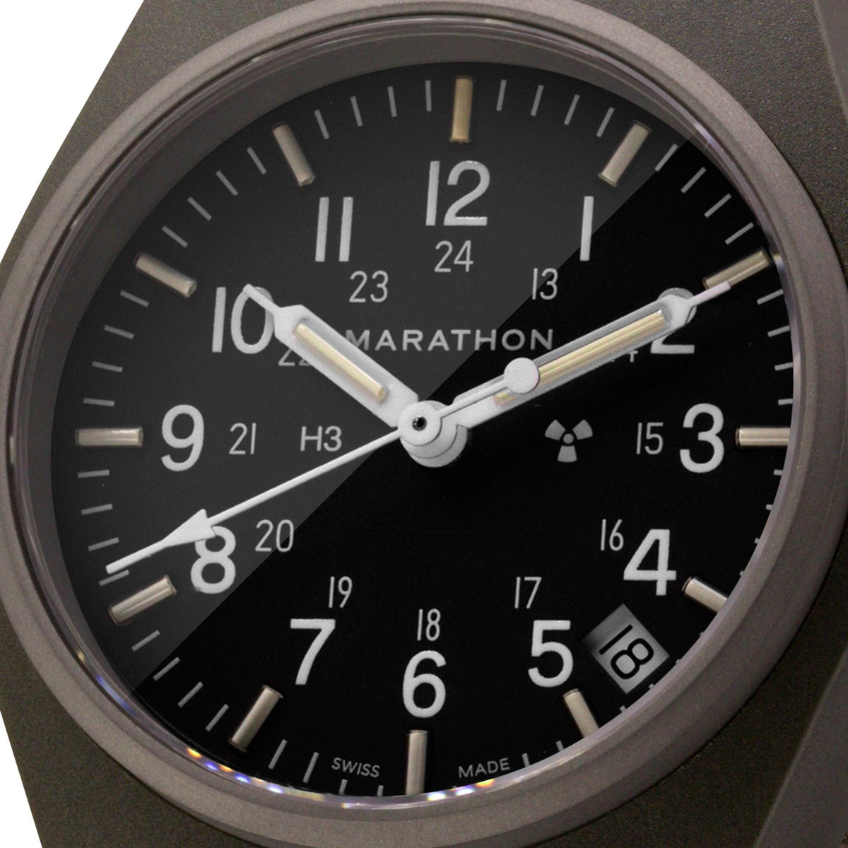 Marathon General Purpose Quartz WW194015SG-0103 watch macro shot showing black dial with 24-hour markings and date display
