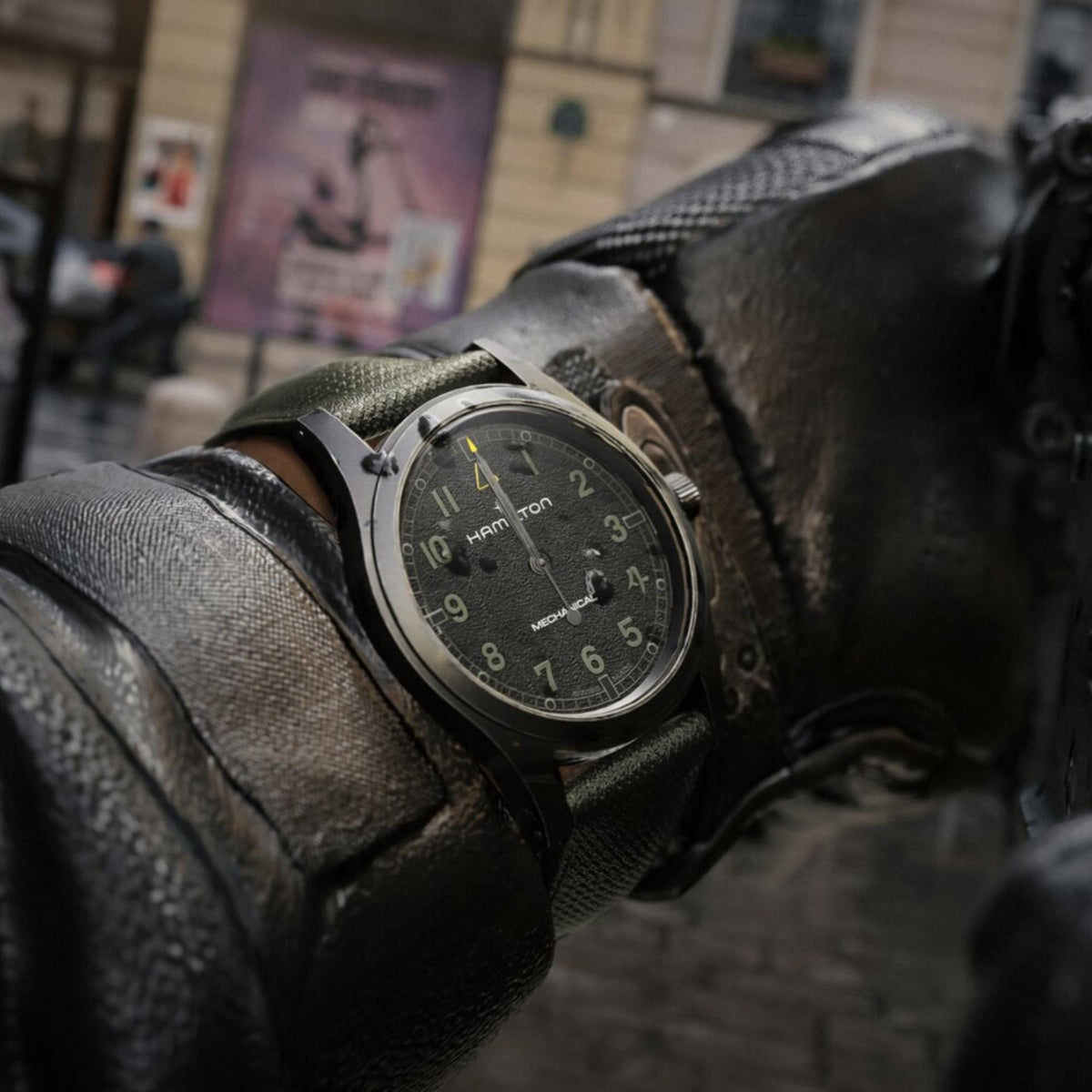 Hamilton Khaki Field Call of Duty H69469930 lifestyle action shot of black dial watch worn over heavy leather sleeve