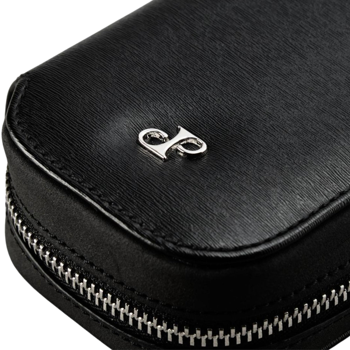 WOLF Philipp 190205 close-up detail shot of silver emblem logo on textured black leather case