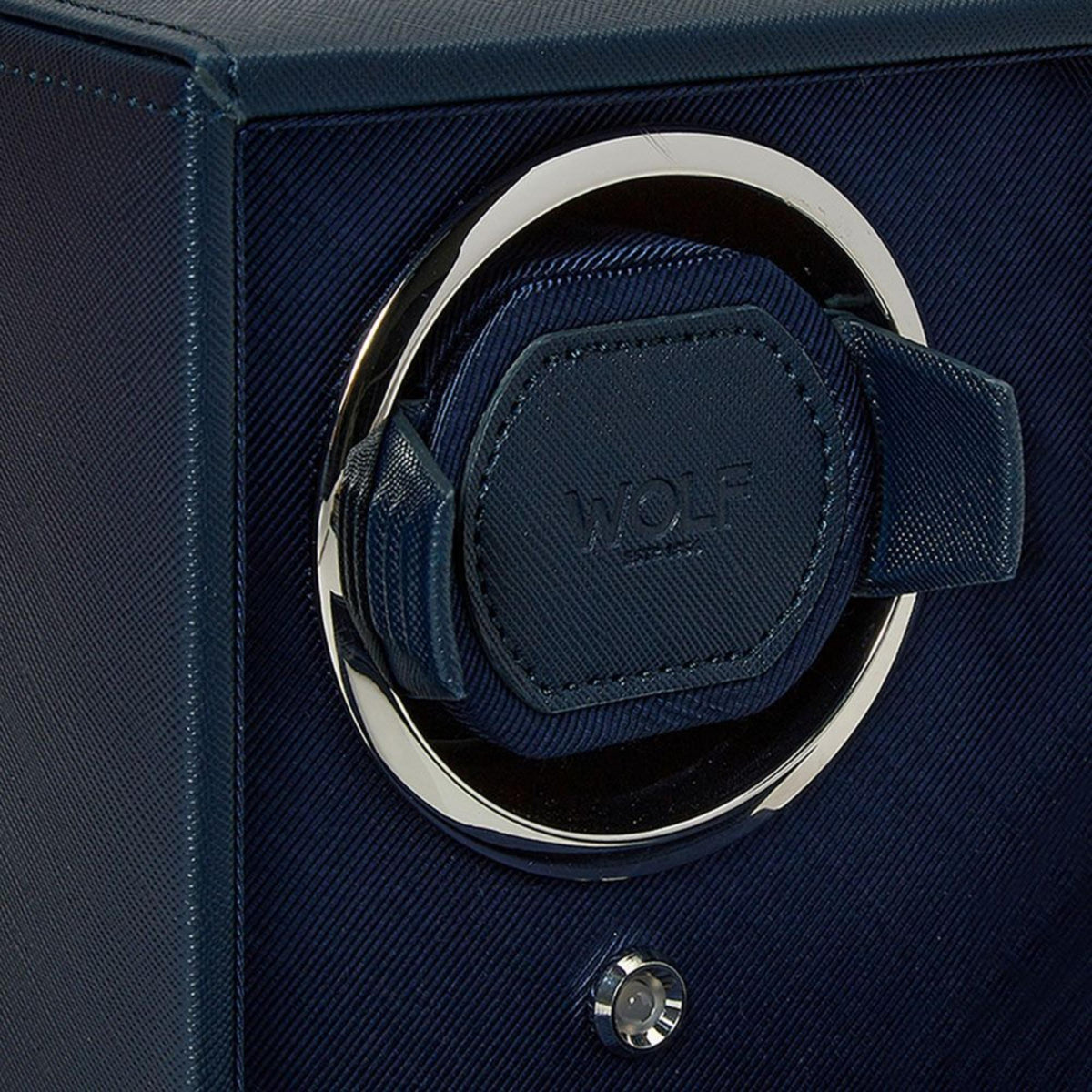 WOLF Cub 461217 close-up detail shot of navy leather watch cushion cuff, chrome bezel ring, and embossed logo