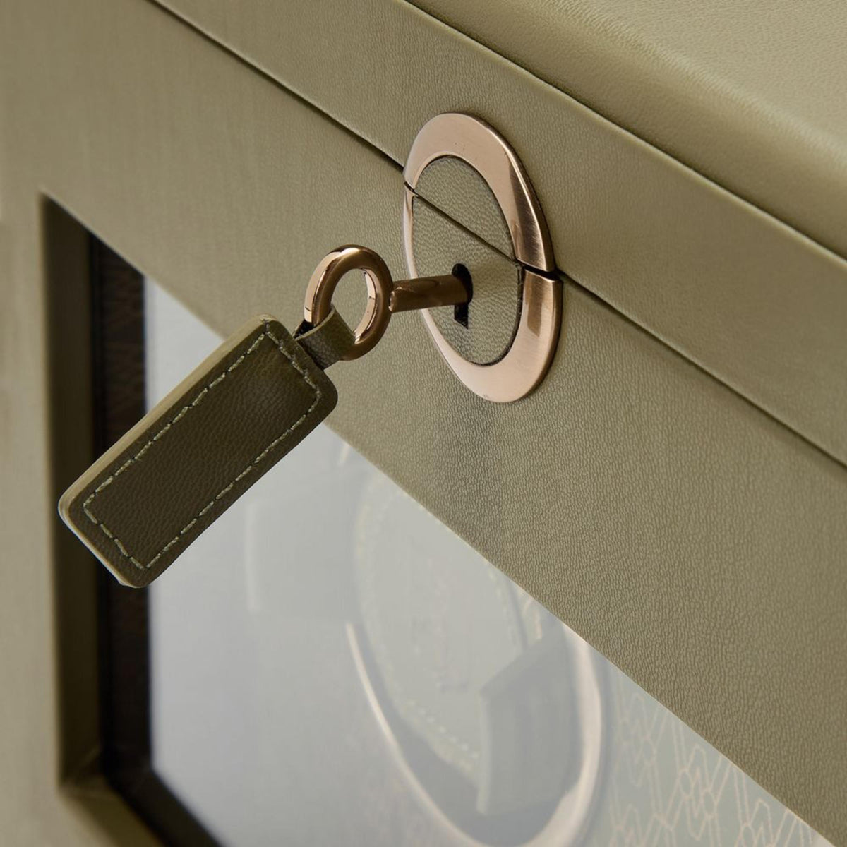 WOLF Earth 190th Anniversary 190441 macro detail shot of key with olive leather fob inserted into round front lock