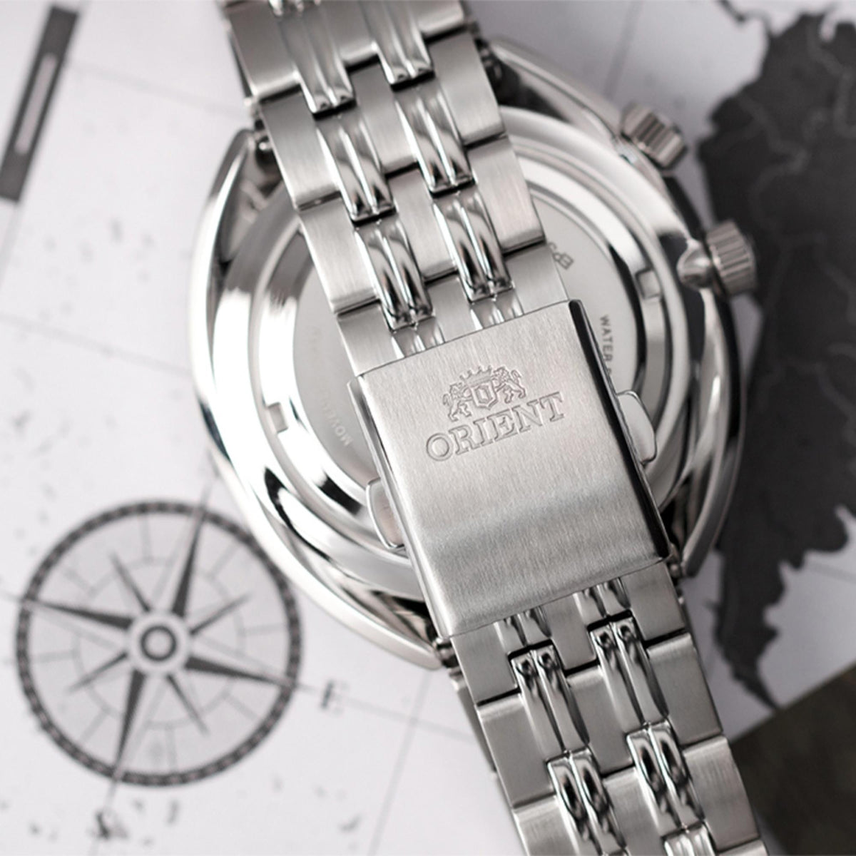 Orient World Map RA-AA0E03L39B rear perspective view highlighting engraved steel bracelet clasp and map background