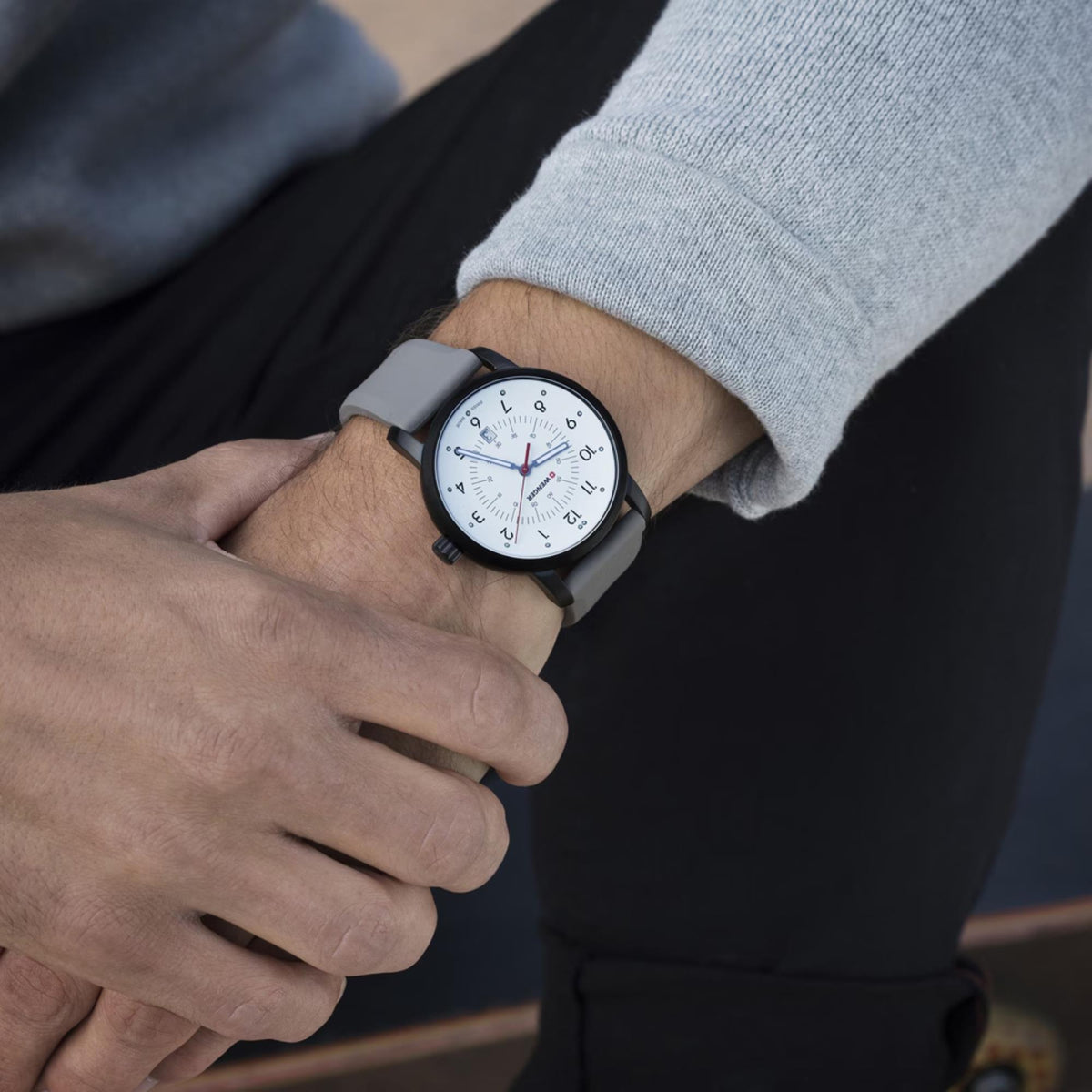 Wenger Avenue 01.1641.121 lifestyle shot of white dial quartz watch worn on wrist with grey silicone strap