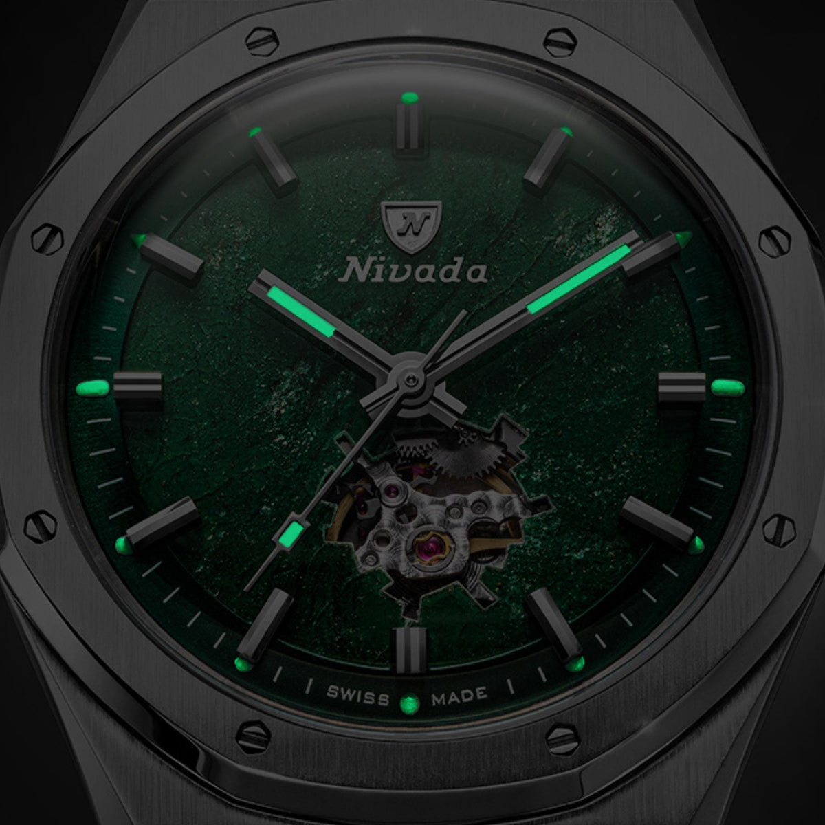 Nivada Grenchen F77 MK2 68051A77-BC macro shot showing green luminous markers and hands glowing in dark setting over aventurine face