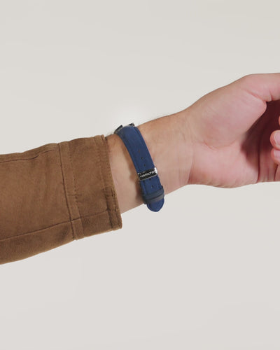 Hamilton Ventura H24411942 blue Alcantara quartz watch on wrist showing butterfly clasp.
