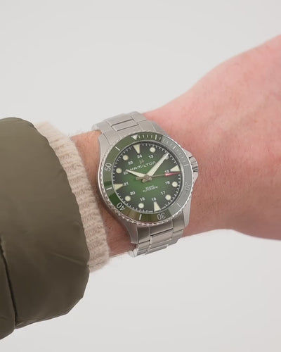 Hamilton Khaki Navy Scuba green dial steel with a unidirectional ceramic bezel watch on wrist