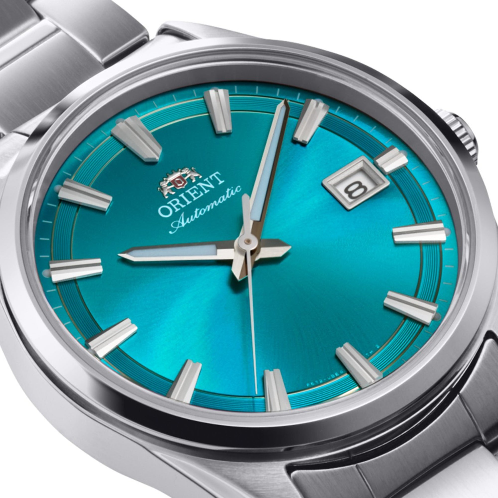 Close-up of an Orient Stretto automatic watch vibrant turquoise dial and stainless steel bracelet.