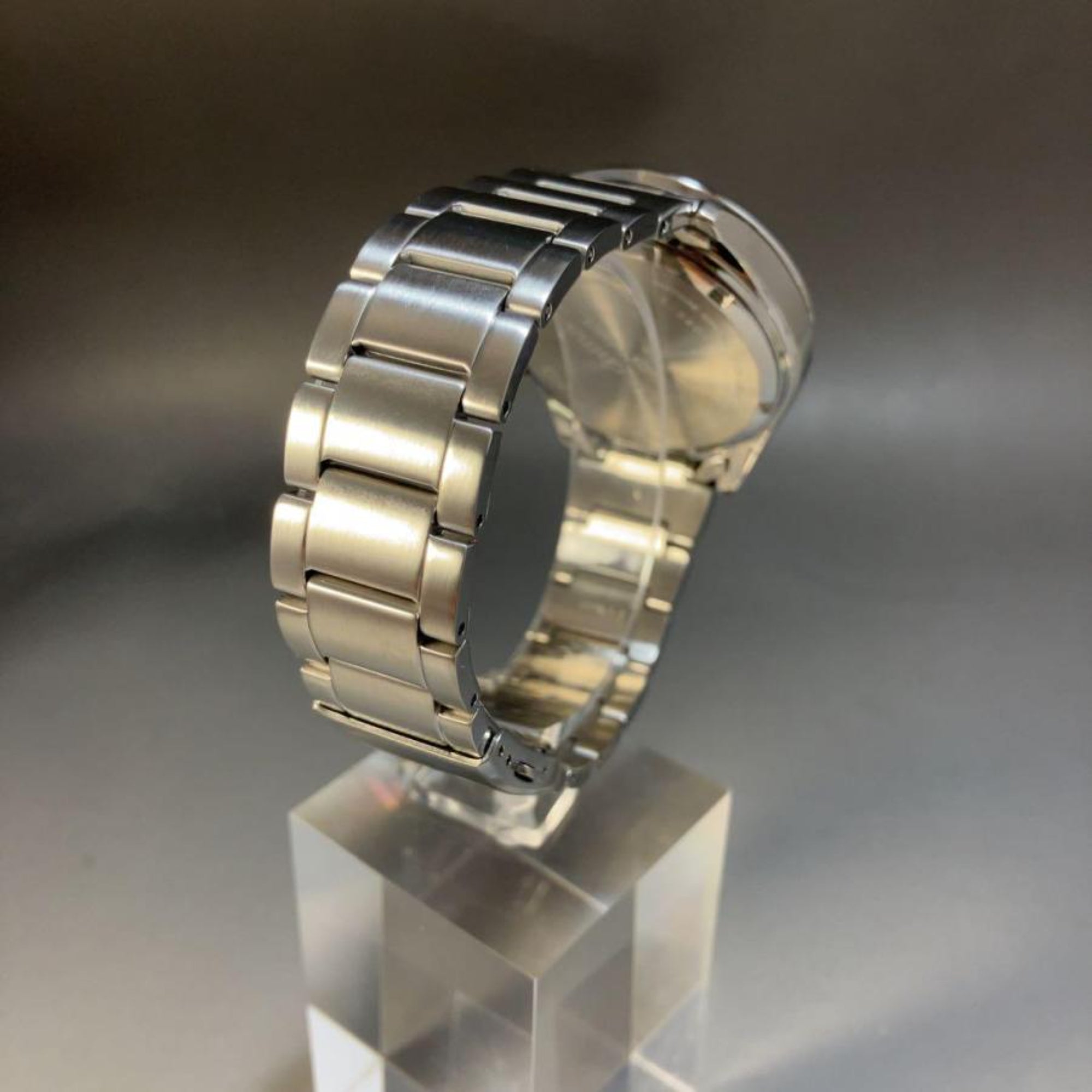 Rear view of a Seiko Essentials Solar Chronograph watch SKU SSC801P1 showcasing the brushed stainless steel link bracelet and caseback